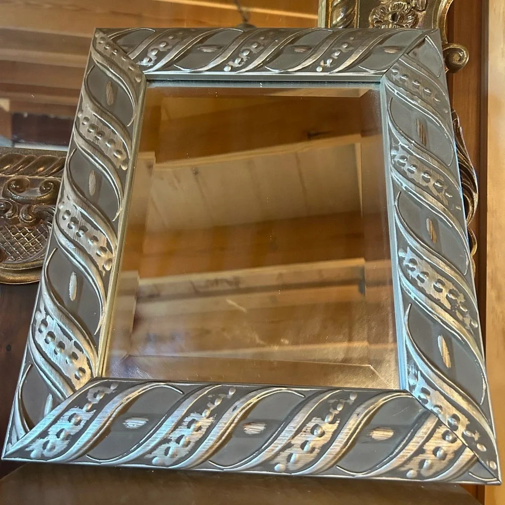 Silver framed mirror with beveled mirror. Good vintage condition.